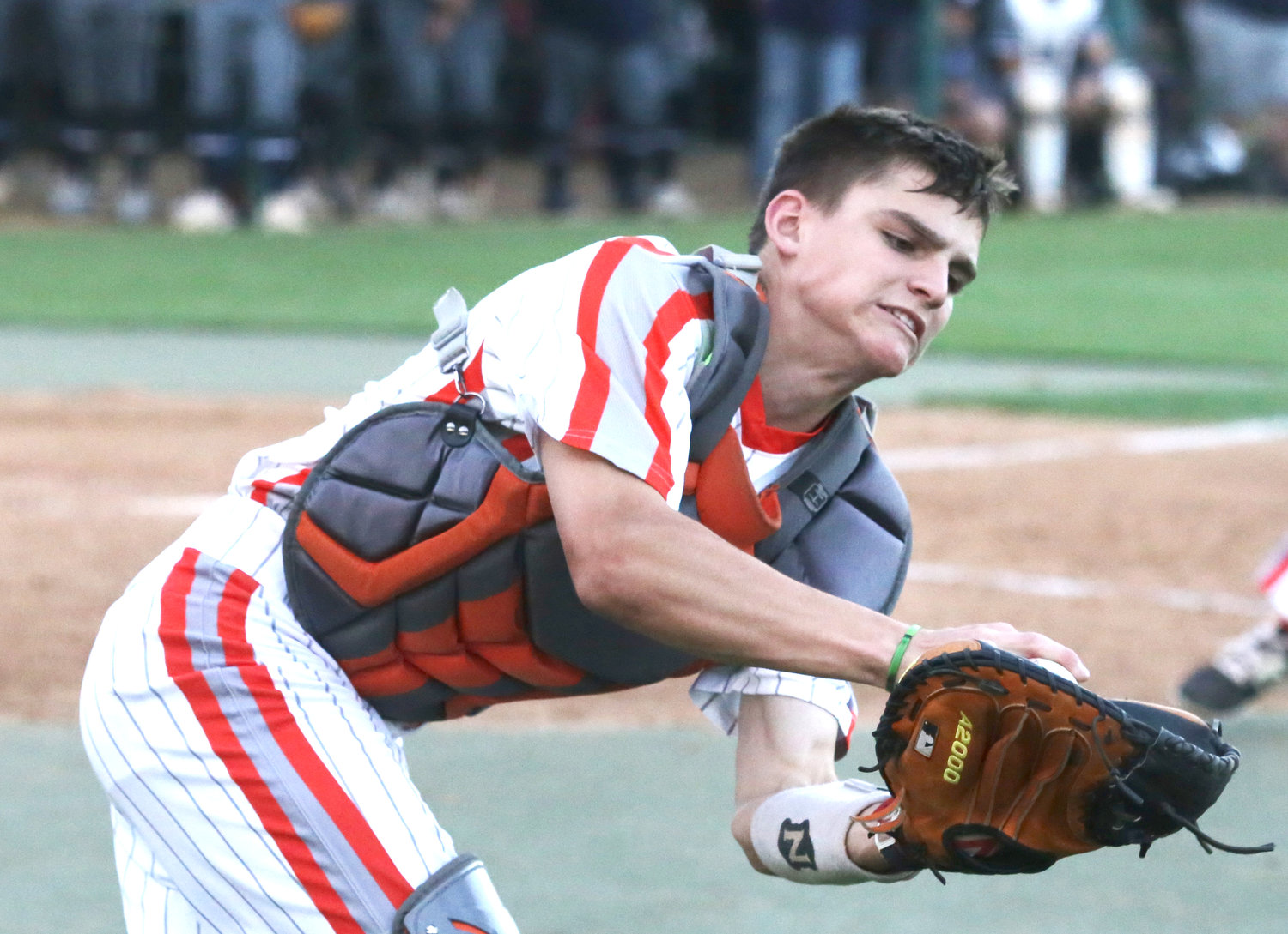 Yellowjacket Coy Anderson secures a tough catch on a towering pop behind home plate.